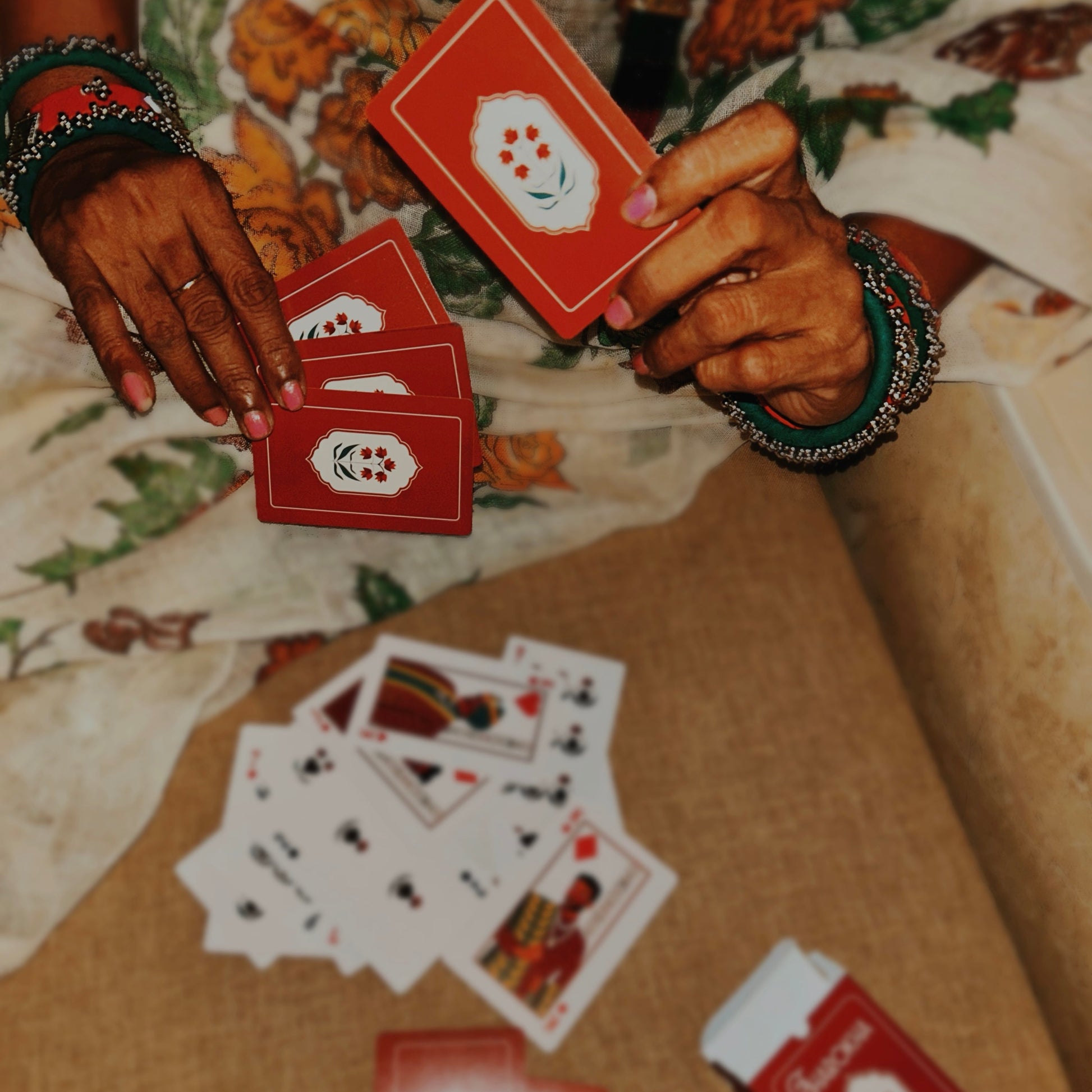 Person playing cards with the Jharokha deck